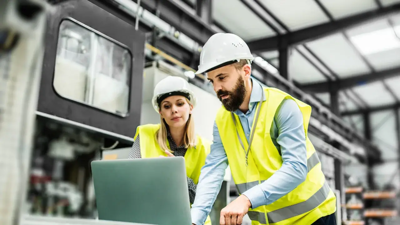 Quality and maintenance team reviewing an inspection report on site